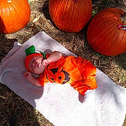 Joseph joined the competition — help win amazing prizes! baby, pumpkin, costume, orange, towel, outdoor, grass, leaf, fall, autumn, sleeping, cute, infant, holiday, seasonal, nature, festive, child, toddler, smiling