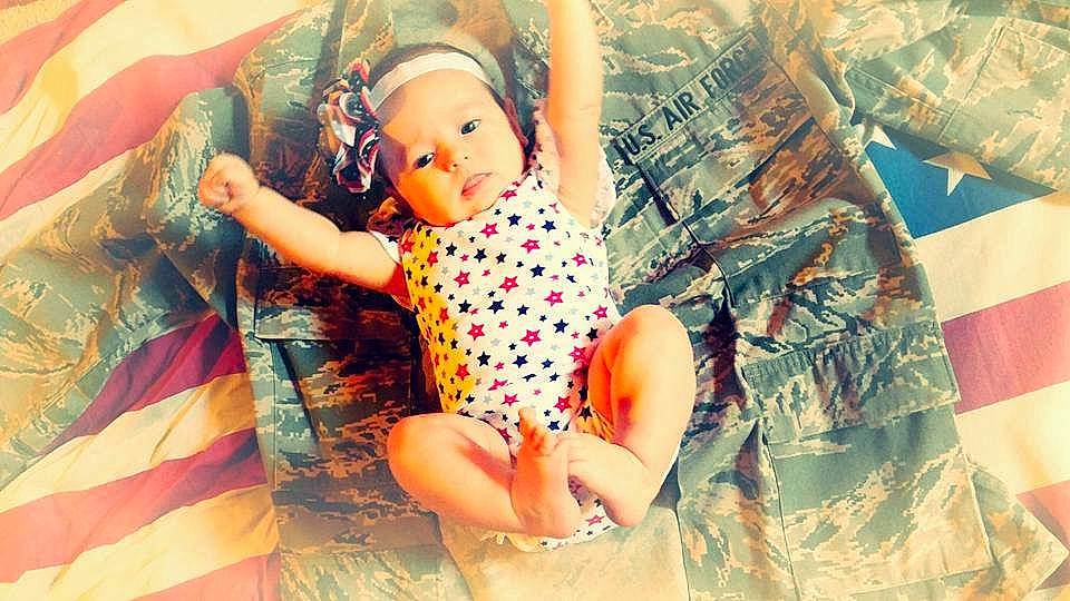 Loveah is registered to the contest to win money with this photo: arm, baby, child, doll, finger, gesture, hand, headwear, leg, pattern, person, skin, summer, toddler