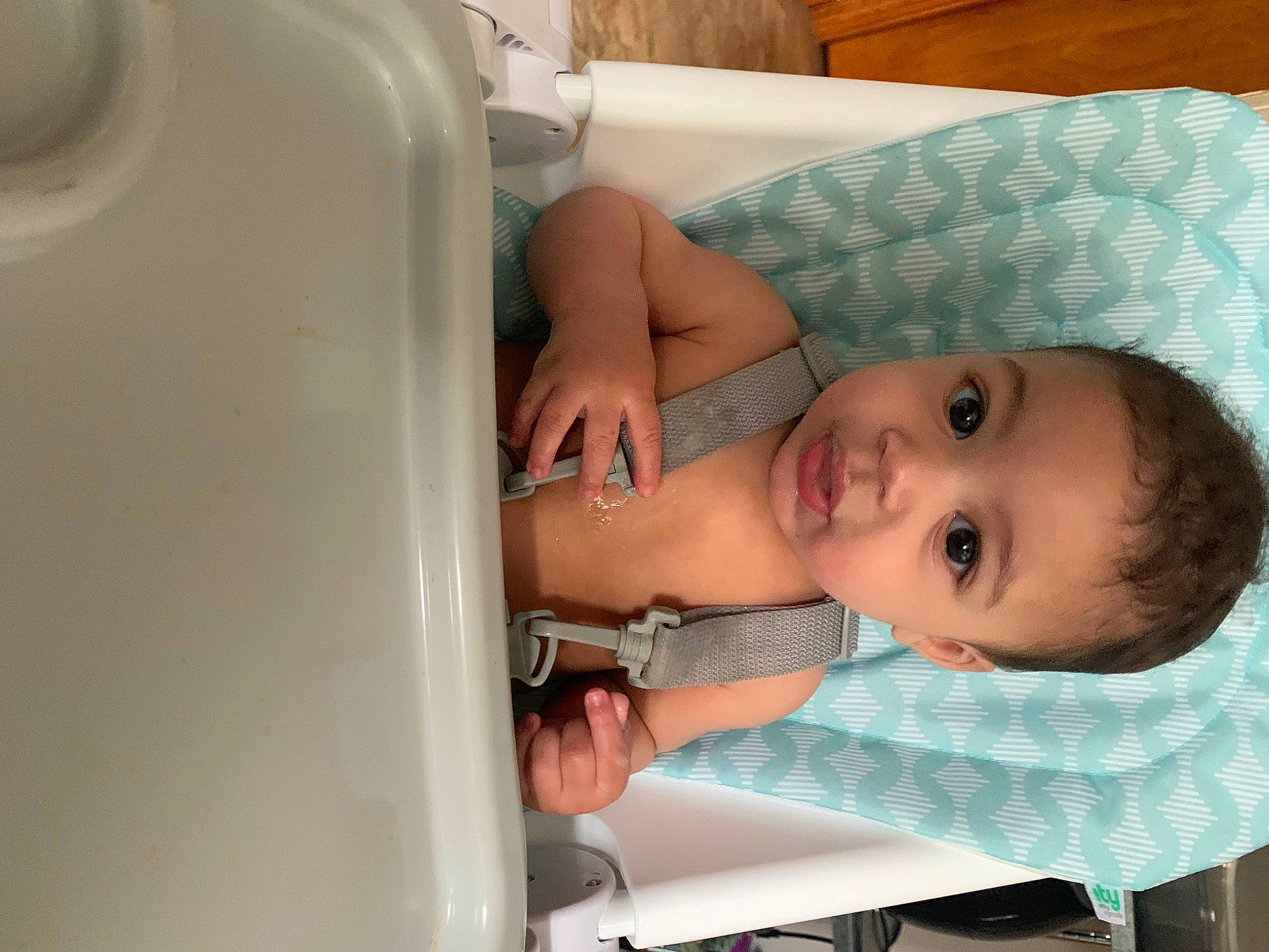 Cairo is registered to the contest to win money with this photo: arm, baby, baby_products, baby_safety, baby_toddler_clothing, chair, child, comfort, gas, linens, pattern, person, product, room, skin, smile, toddler, wood