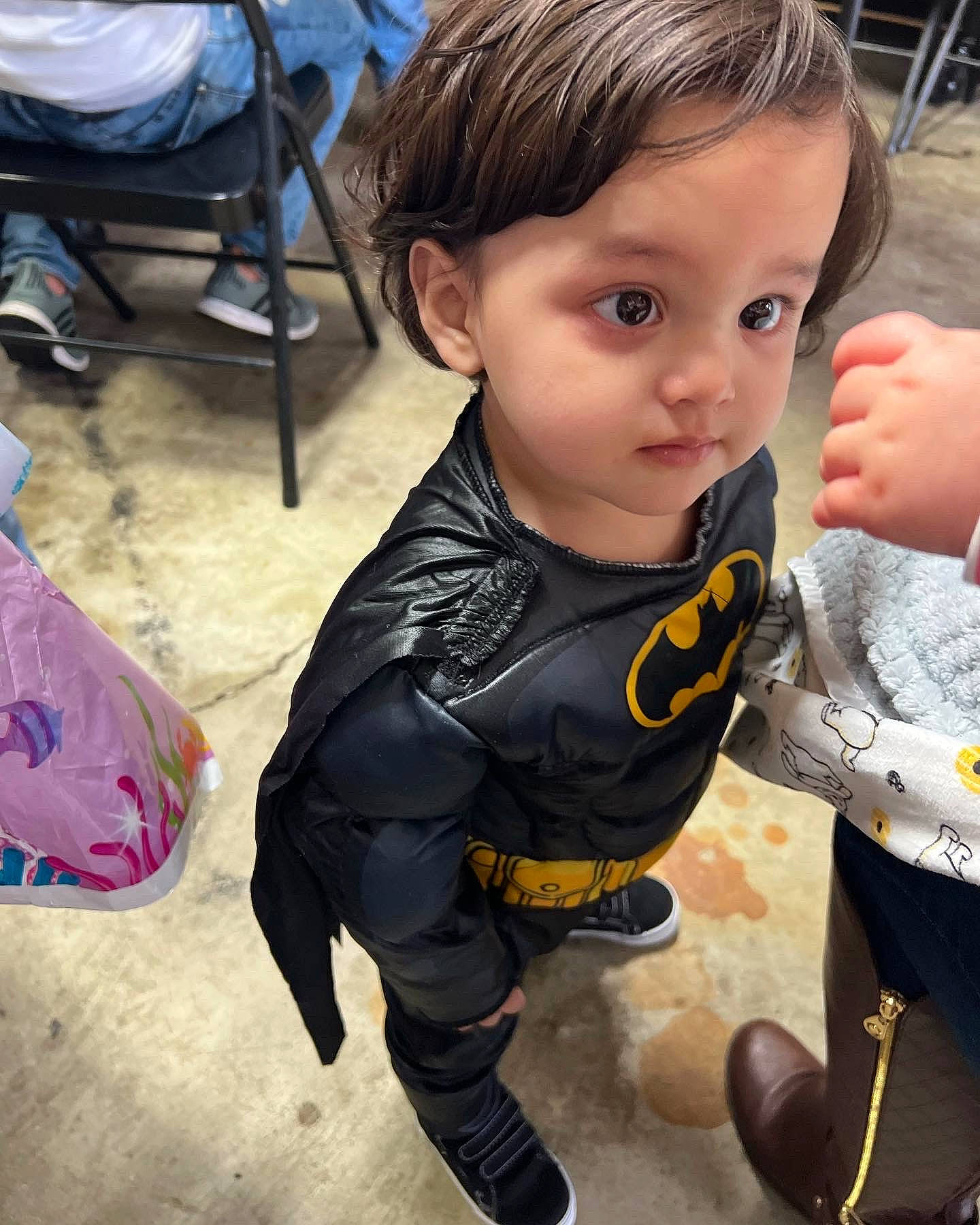 Jesus is registered to the contest to win money with this photo: baby, chair, child, cool, costume, eyelash, fictional_character, flooring, fun, fur, happy, iris, person, personal_protective_equipment, sitting, sleeve, t_shirt, toddler, toy