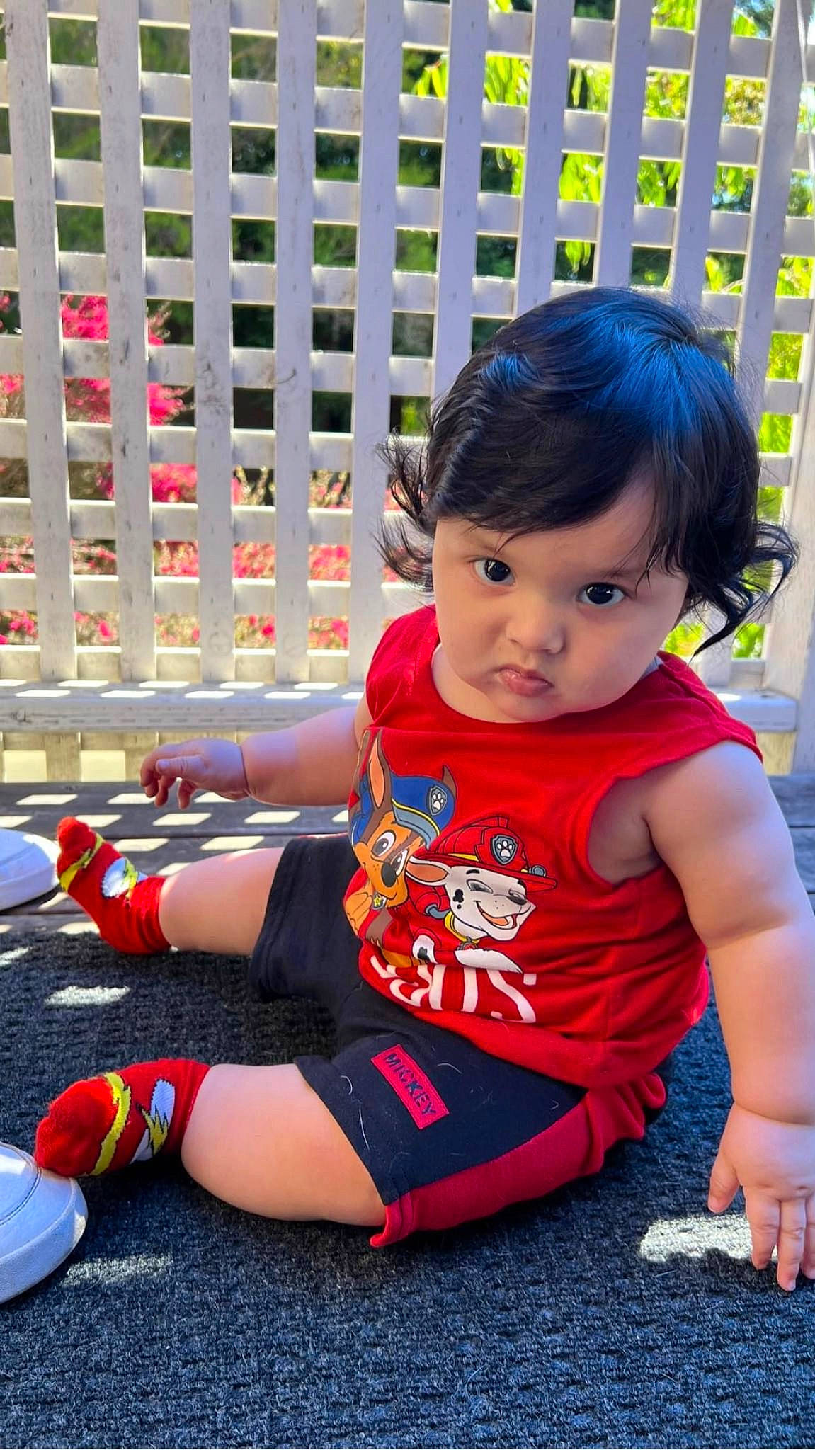 Jesus is registered to the contest to win money with this photo: baby, baby_toddler_clothing, carmine, child, flooring, foot, fun, grass, happy, human_leg, knee, leisure, person, play, recreation, shorts, sitting, sleeve, sneakers, thigh