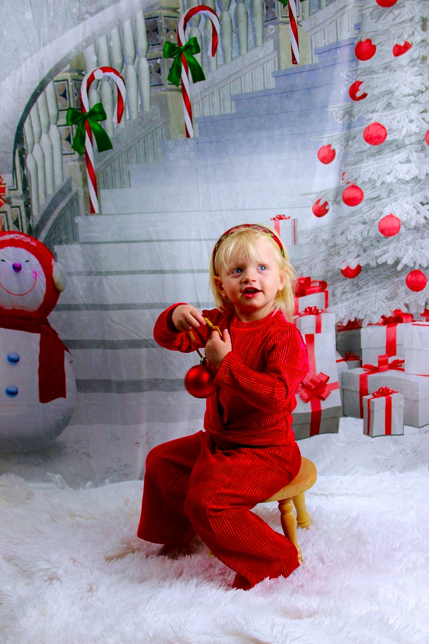 Raelyn is registered to the contest to win money with this photo: child, christmas_decoration, christmas_eve, christmas_ornament, christmas_tree, dress, event, facial_expression, fun, happy, head, holiday, holiday_ornament, ornament, people_in_nature, person, red, smile, snow, toddler