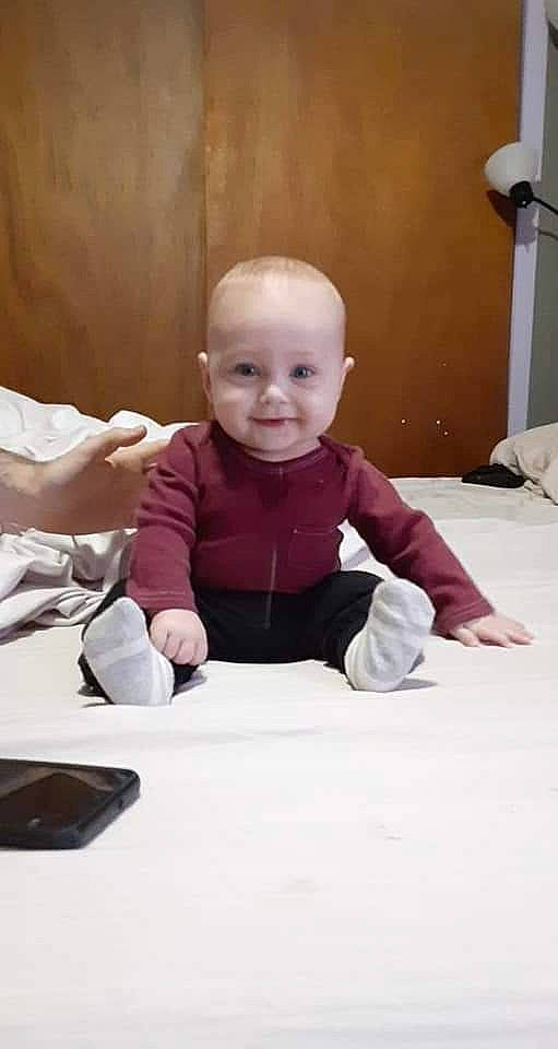 Ember is registered to the contest to win money with this photo: arm, art, baby, baby_toddler_clothing, cheek, child, comfort, communication_device, facial_expression, finger, flash_photography, floor, flooring, fun, happy, joy, person, sitting, sleeve, smile