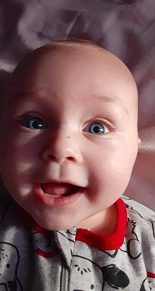 Ember is registered to the contest to win money with this photo: baby, baby_toddler_clothing, cheek, child, chin, ear, eyebrow, eyelash, flash_photography, happy, iris, jaw, lip, mouth, nose, person, pink, skin, smile, toddler