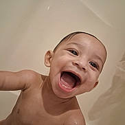 Iv is registered to the contest to win money with this photo: baby, infant, child, bath, bathtub, water, wet, smiling, laughing, open_mouth, face, portrait, close_up, outdoorless, skin, arm, head, happy, bathroom, photography