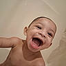 baby, infant, child, bath, bathtub, water, wet, smiling, laughing, open_mouth, face, portrait, close_up, outdoorless, skin, arm, head, happy, bathroom, photography