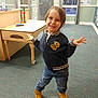 Corbin joined the competition — help win amazing prizes! child, smiling, playful, indoor, classroom, carpet, table, toy, window, jacket, jeans, boots, person, young, education, furniture, colorful, happy, pose, floor