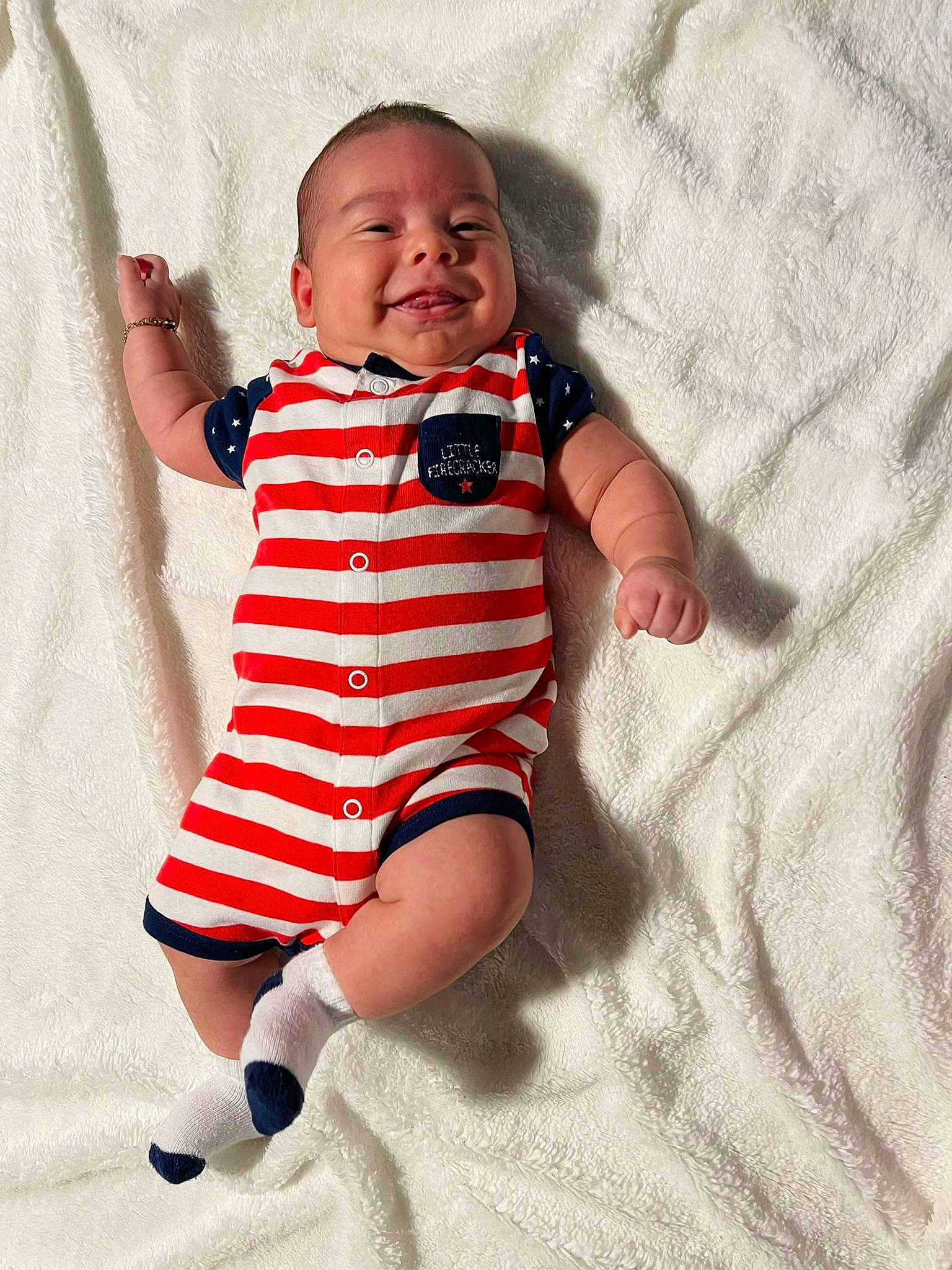 Lucas is registered to the contest to win money with this photo: arm, baby, baby_products, baby_toddler_clothing, child, collar, comfort, face, gesture, happy, joy, linens, neck, pattern, person, product, sleeve, smile, t_shirt, textile