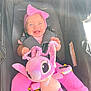 baby, child, smiling, pink_bow, headband, plush_toy, purple_toy, stroller, seatbelt, pink_pants, happy, infant, cute, toy, portrait, baby_clothing, child_in_stroller, daylight, sunlight, indoors
