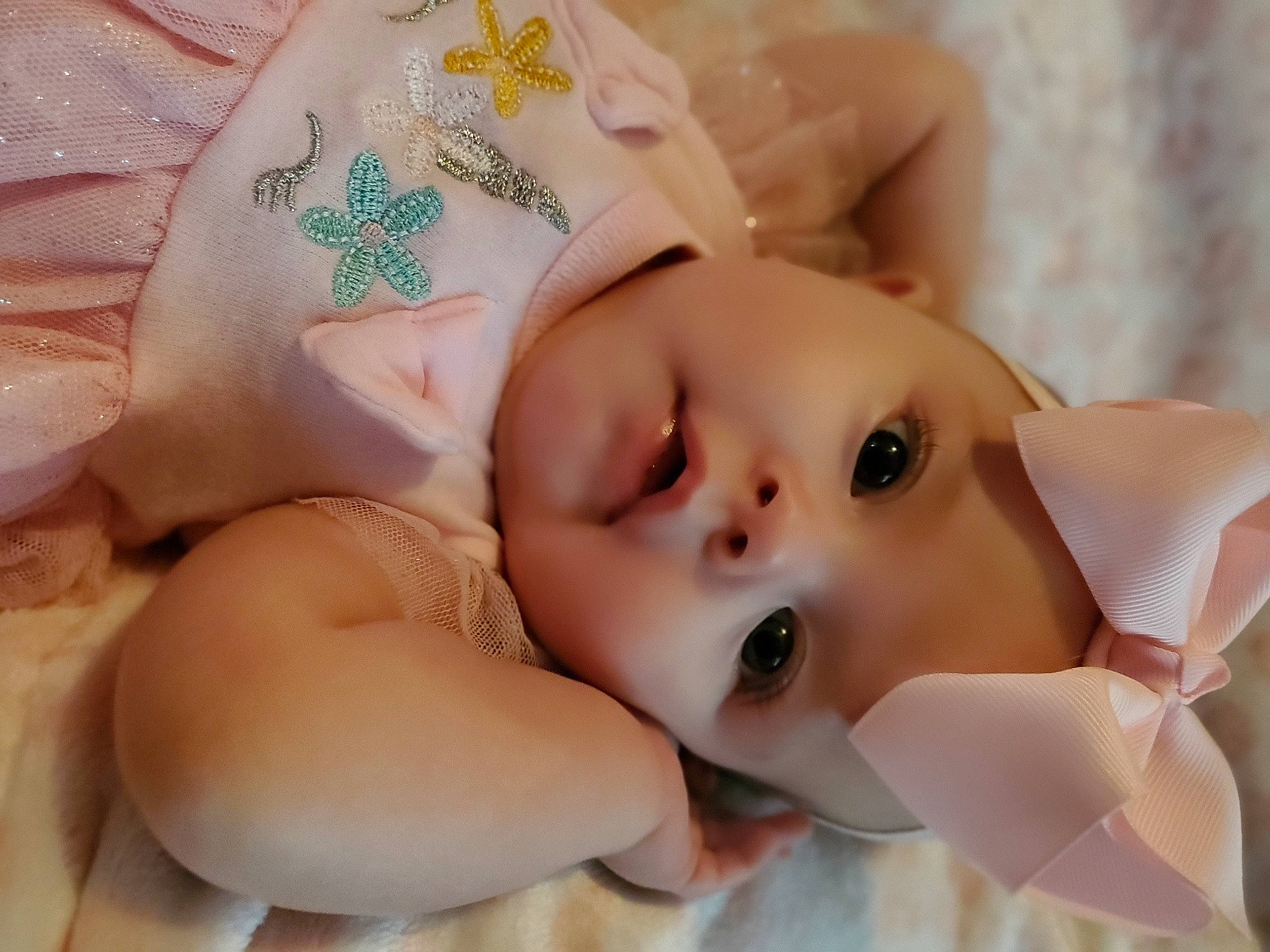 Eliana is registered to the contest to win money with this photo: arm, baby, cheek, eye, eyebrow, eyelash, facial_expression, finger, hand, happy, head, headgear, headwear, iris, lip, mouth, nose, person, pink, skin