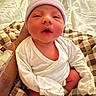 Lennox is registered to the contest to win money with this photo: newborn, baby, infant, child, portrait, face, hat, beanie, white_clothing, onesie, blanket, plaid, bed, sitting, indoors, cozy, sleepy, awake, adorable, photography
