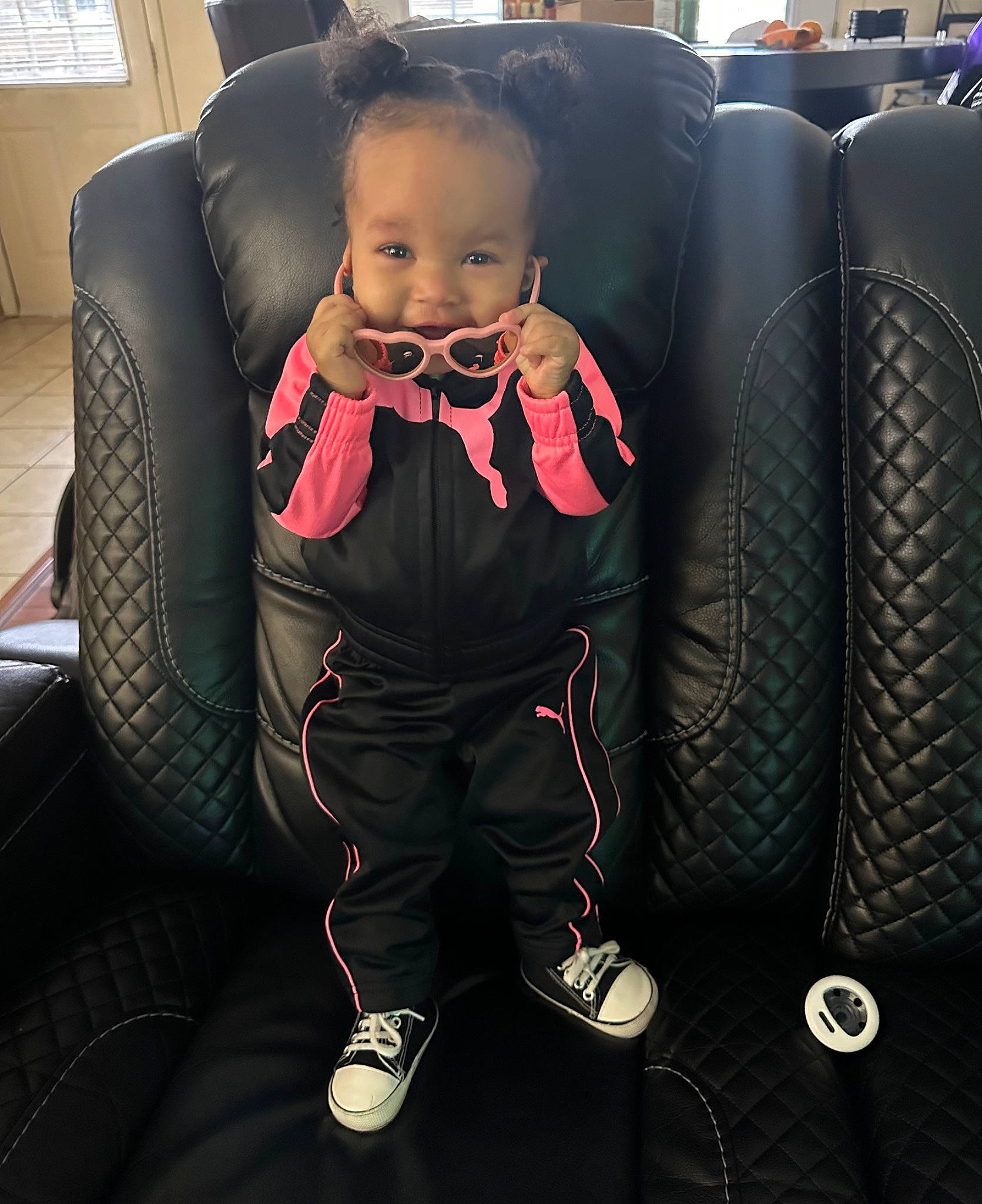 Alaïa is registered to the contest to win money with this photo: auto_part, automotive_design, baby, car_seat, car_seat_cover, child, comfort, family_car, fashion_accessory, flooring, formal_wear, fun, leather, luxury_vehicle, person, shoe, sitting, smile, suit, tie