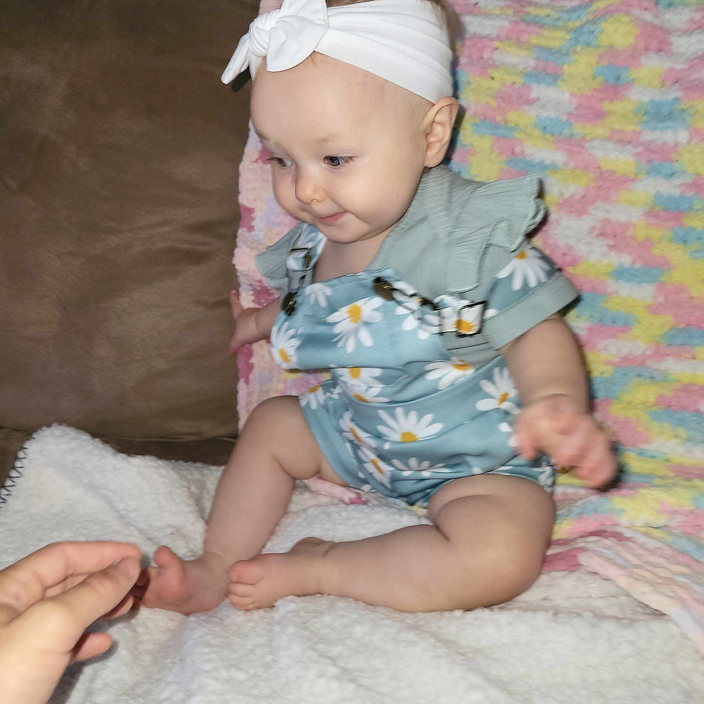 Zoey Jewels is registered to the contest to win money with this photo: accessories, baby, bed, bodypart, clothing, couch, cushion, dress, face, finger, furniture, hand, head, headband, homedecor, person, photography, portrait, quilt, sitting