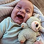 Kassim a rejoint le concours — aidez-le/la à gagner de superbes lots ! baby, blanket, child, clothing, comfort, cozy, cute, expression, face, happy, indoors, infant, joy, lying_down, plush_toy, smiling, soft_toy, toy, warm, young_child