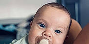 Kassim a rejoint le concours — aidez-le/la à gagner de superbes lots ! baby, blue_eyes, child, close_up, comfort, curious, cute, face, human, indoors, infant, light_green, pacifier, portrait, ribbed_clothing, sitting, skin, soft_focus, warm, young_child