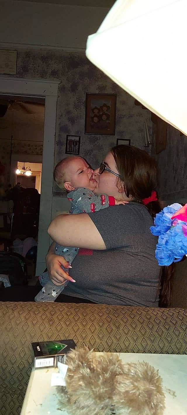 Conner is registered to the contest to win money with this photo: child, event, eyewear, fun, hairstyle, happy, hug, interaction, leisure, party, person, picture_frame, room, shoulder, sitting, sunglasses, t_shirt, vacation