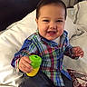 Aaron joined the competition — help win amazing prizes! bed, child, clothing, colorful, cute, face, furniture, hand, happy, indoor, infant, person, pillow, plaid_shirt, playful, sitting, smile, toddler, toy, young