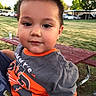Aaron joined the competition — help win amazing prizes! bench, car, casual, child, clothing, daylight, expression, face, grass, hair, holding, nature, outdoor, park, person, picnic_table, shirt, smile, toddler, tree