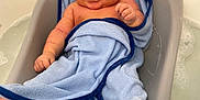 Exzavian is registered to the contest to win money with this photo: baby, bathing, bathtub, blanket, childbirth, crib, face, furniture, happy, head, infantbed, newborn, person, photography, portrait, smile, towel, tub