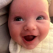 Matilda joined the competition — help win amazing prizes! baby, smile, face, closeup, infant, eyes, expression, joy, blanket, skin, cheeks, mouth, cute, young, happiness, portrait, human, babywear, head, warmth