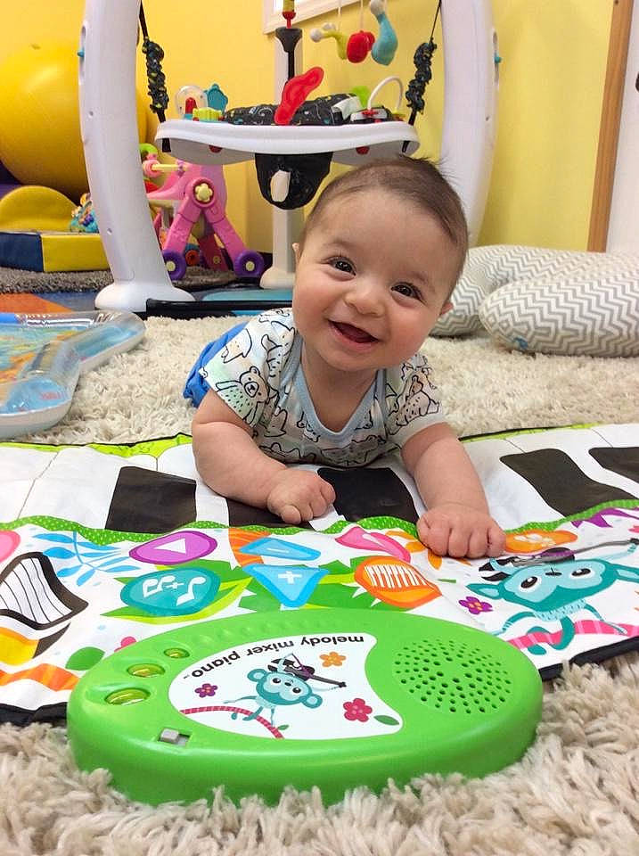 Lawrence is registered to the contest to win money with this photo: baby, baby_playing_with_toys, baby_products, baby_toddler_clothing, chair, child, event, fun, furniture, green, happy, head, joy, leisure, person, play, room, smile, table, toddler