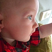 Dahlia joined the competition — help win amazing prizes! baby, infant, child, face, profile, side_view, blue_eyes, bald_head, plaid_clothing, red_clothing, arm, cheek, nose, ear, blanket, bedding, electrical_outlet, closeup, portrait, looking