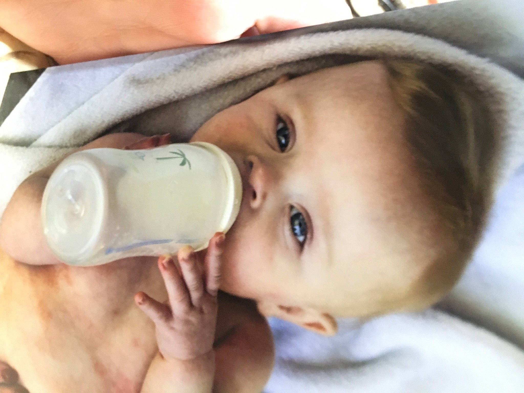 Blake is registered to the contest to win money with this photo: baby, baby_bottle, bottle, cheek, drinking, drinkware, ear, eye, eyebrow, eyelash, finger, fluid, hand, head, infant_formula, lip, liquid, nose, person, plastic_bottle