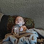 Valentino is registered to the contest to win money with this photo: baby, bottle, blanket, couch, sleeping, child, indoor, cozy, comfort, rest, person, infant, clothing, furniture, head, face, peaceful, holding, soft, wrapped
