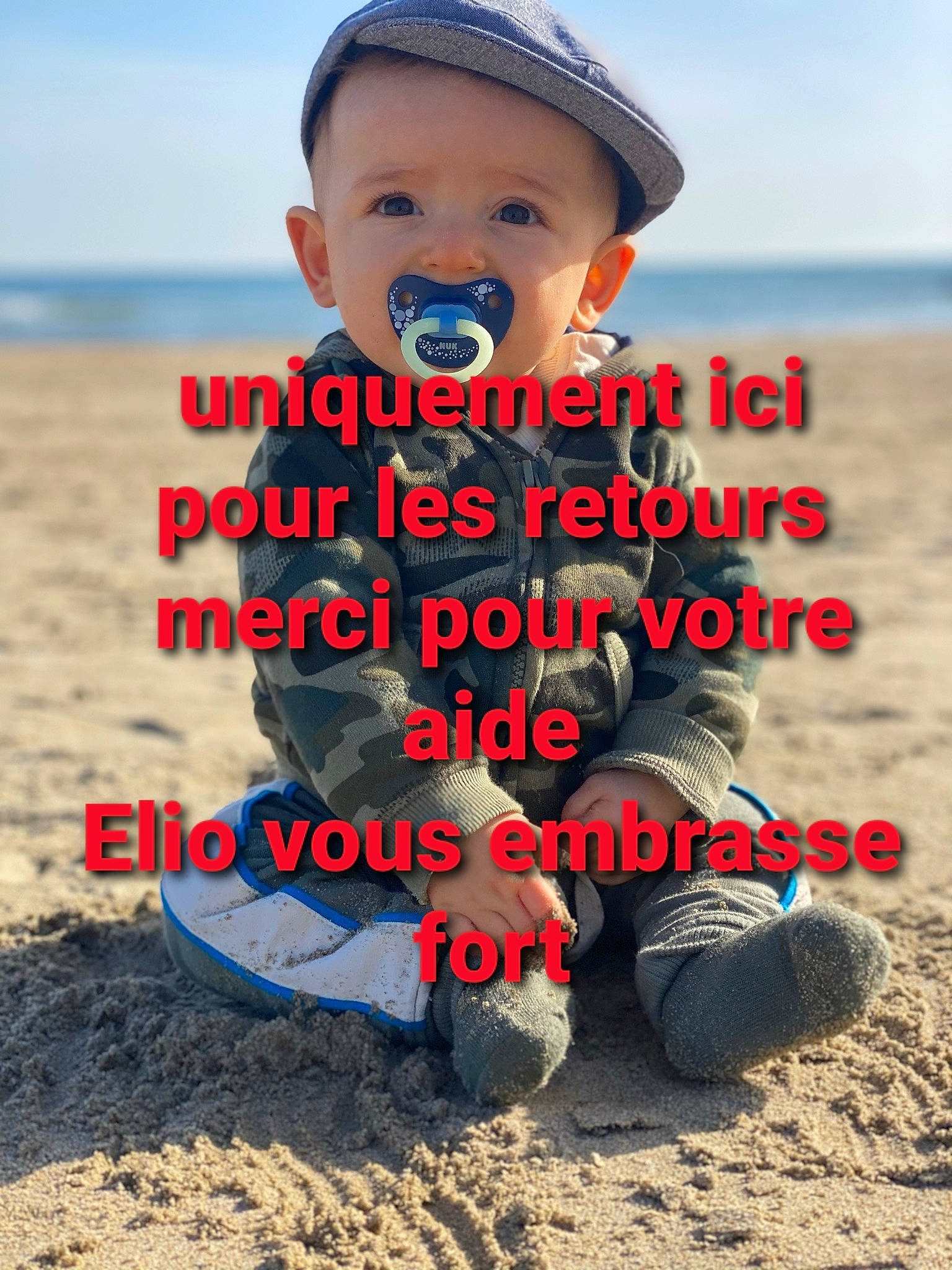 Elio participe au concours pour gagner de l'argent avec cette photo : baby_toddler_clothing, beach, cap, child, cool, font, fun, happy, hat, landscape, people_in_nature, person, sand, sitting, sky, sleeve, soil, summer, t_shirt, toddler