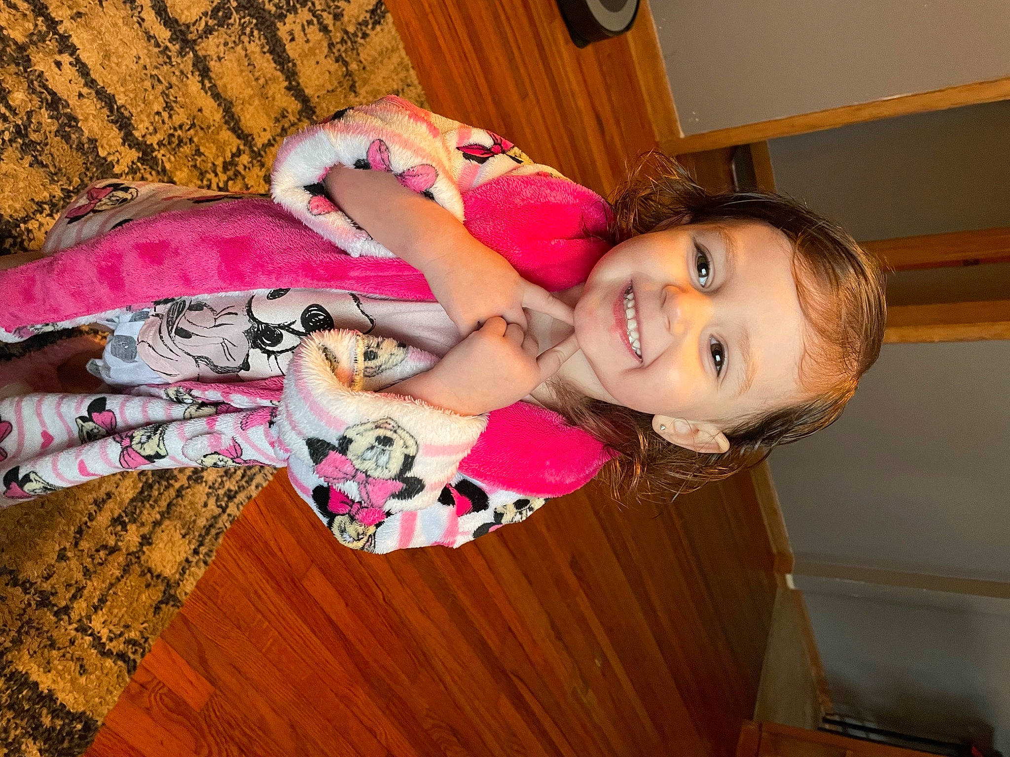 Arabella is registered to the contest to win money with this photo: baby_toddler_clothing, cheek, clothing, dress, eye, facial_expression, finger, floor, flooring, hand, happy, head, human_body, joy, leg, person, pink, skin, smile, thigh