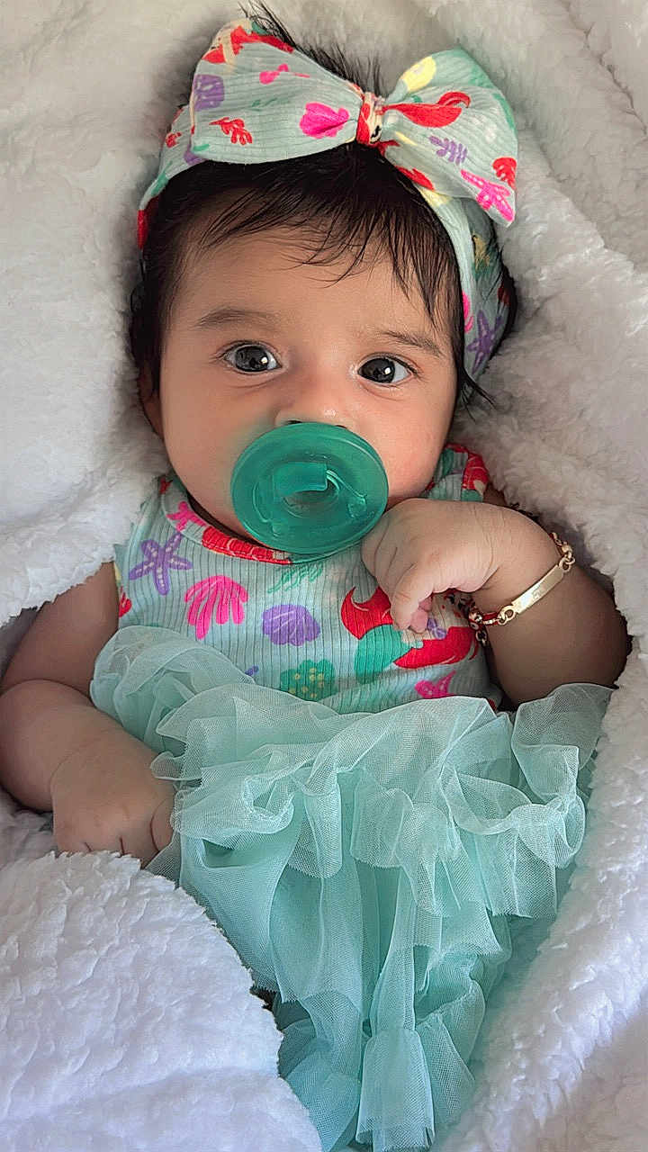 Sofía is registered to the contest to win money with this photo: baby, pacifier, headband, blanket, infant, cute, clothing, tulle, bracelet, portrait, closeup, soft_texture, young_child, colorful, sleepwear, resting, indoors, baby_girl, adorable, comfort