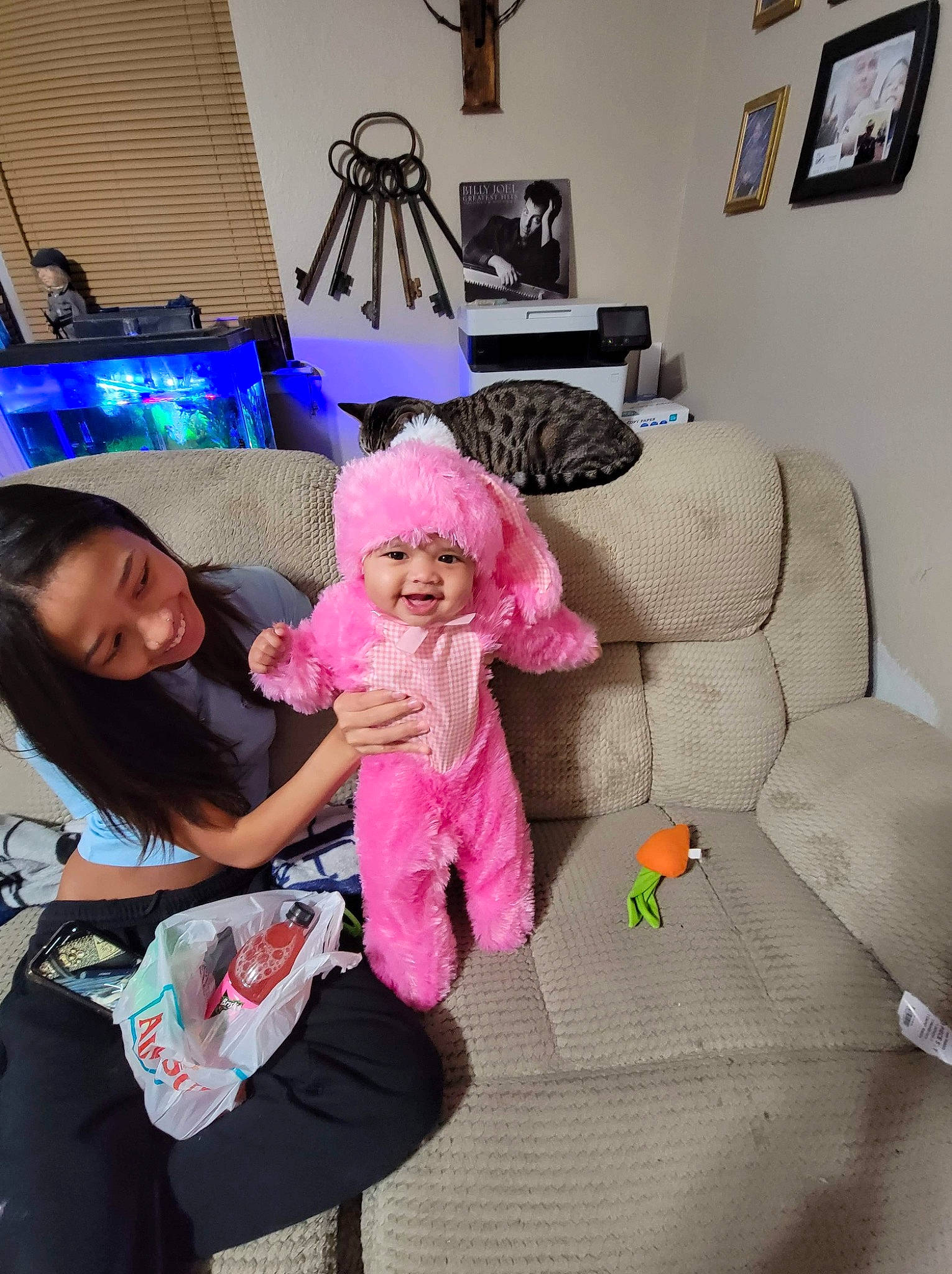 Kiara Kalani is registered to the contest to win money with this photo: child, comfort, couch, event, fashion_accessory, flooring, fun, happy, hat, headwear, joy, lamp, linens, living_room, magenta, person, picture_frame, pillow, pink, purple