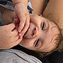 Rylan is registered to the contest to win money with this photo: toddler, child, face, hand, skin, hair, smile, close-up, portrait, relaxed, playful, expression, casual, person, young_child, indoors, fingers, nail, eyelashes, comfort