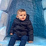 child, toddler, jacket, boots, stairs, blue, outdoor, curious, puffy_jacket, winter, texture, concrete, sitting, young_child, casual_clothing, small_person, cold_weather, playground, candid, portrait