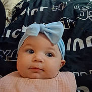 Aspyn joined the competition — help win amazing prizes! baby, bib, blanket, bow, carpet, casual, child, clothing, cute, expression, face, hand, headband, indoor, infant, pattern, person, resting, soft, toy