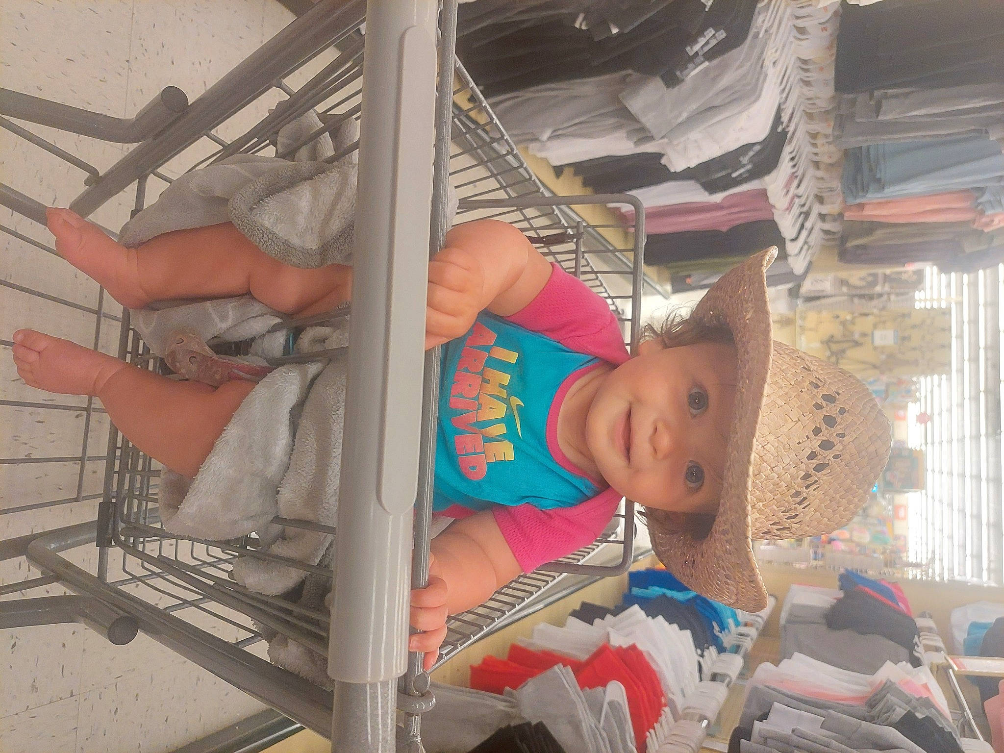 Kaylee is registered to the contest to win money with this photo: baby, child, elbow, fashion_accessory, fedora, fun, hat, headwear, human_leg, joy, person, room, sun_hat, t_shirt, thigh, toddler, vacation