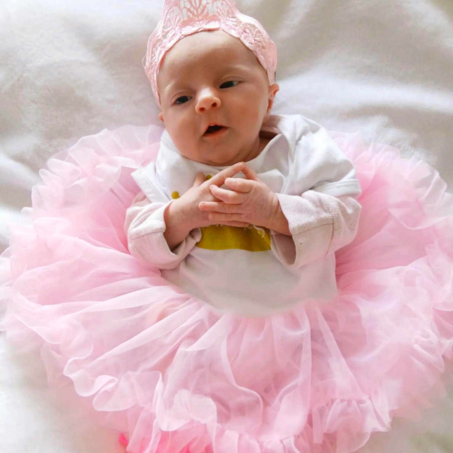 Julyanna participe au concours pour gagner de l'argent avec cette photo : adorable, baby, child, clothing, cute, face, footwear, hands, headwear, infant, lace_crown, laying_down, newborn, pink_shoes, pink_tutu, portrait, sleepwear, small_hands, soft_texture, white_blanket