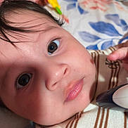 Dereck joined the competition — help win amazing prizes! baby, close_up, face, eyes, infant, child, skin, lips, hair, clothing, striped, hand, object, indoor, portrait, cute, expression, soft_light, background, colorful