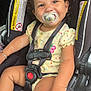 Kyelynn joined the competition — help win amazing prizes! toddler, child, car_seat, pacifier, curly_hair, smiling, baby_clothes, safety_harness, seatbelt, infant, cute, happy, indoors, person, young_child, sitting, car_interior, bright, closeup, skin