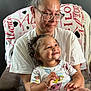 Kyelynn joined the competition — help win amazing prizes! toddler, child, woman, glasses, smile, happy, chair, blanket, love, curly_hair, casual_clothing, indoor, family, affection, portrait, seated, hands, person, expression, comfort