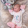 newborn, baby, plush_toy, elephant, pink_clothing, white_clothing, fur_blanket, infant, soft_texture, cute, sleepy, child, portrait, lying_down, cozy, toy, decorative_text, baby_clothes, soft_lighting, peaceful
