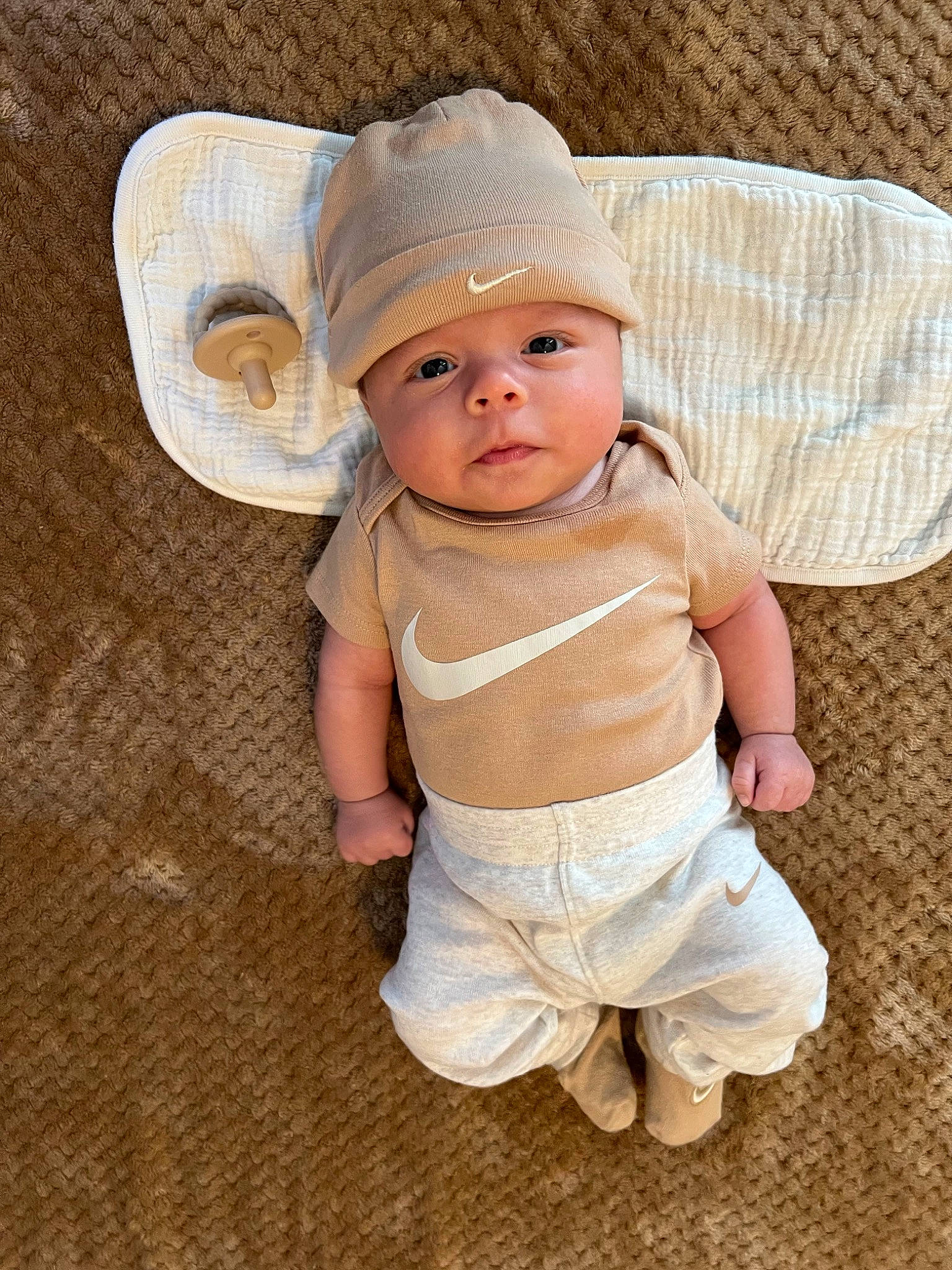 Andres joined the competition — help win amazing prizes! baby, baby_toddler_clothing, beige, cap, cheek, child, collar, eye, face, fashion_accessory, grass, hat, headgear, headwear, pattern, peach, person, sitting, sleeve, sun_hat