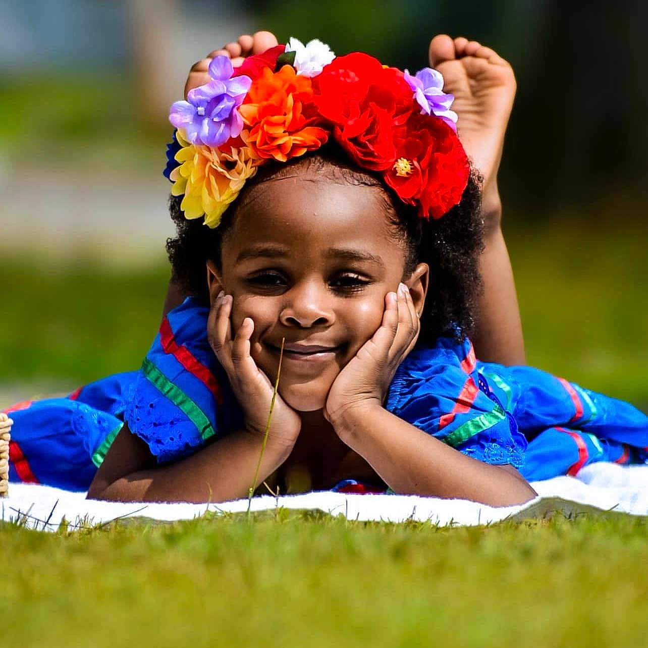 Annabelle Jaycee joined the competition — help win amazing prizes! blue_dress, child, colorful, cute, face, feet, flower_crown, grass, hands, happy, headband, laying_down, nature, outdoor, person, portrait, relaxed, smiling, sunny, young