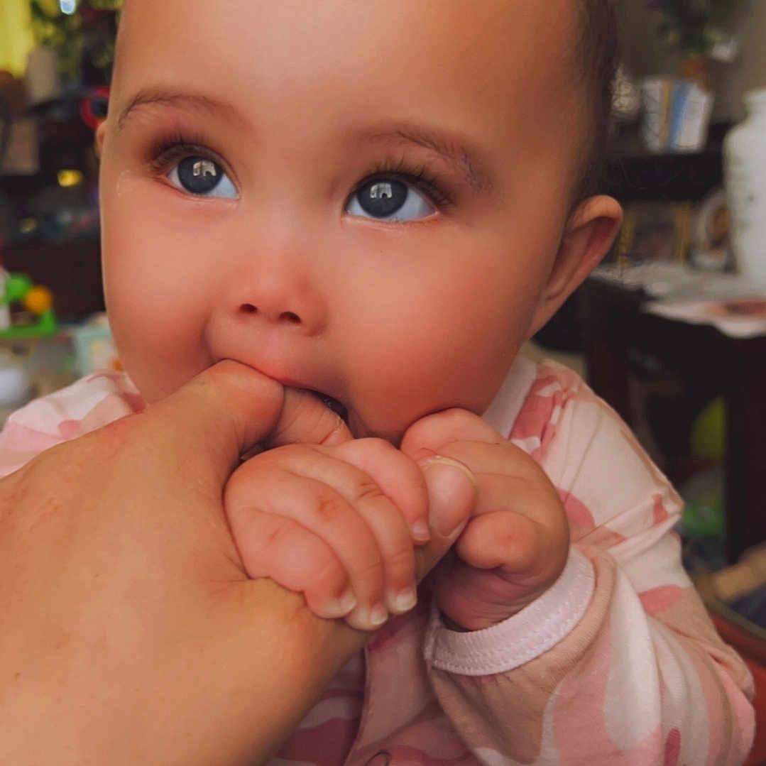 Irilynn is registered to the contest to win money with this photo: arm, baby, biting, bodypart, eating, face, finger, food, hand, happy, head, mouth, nail, person, photography, portrait, shoulder, skin, smile, wrist