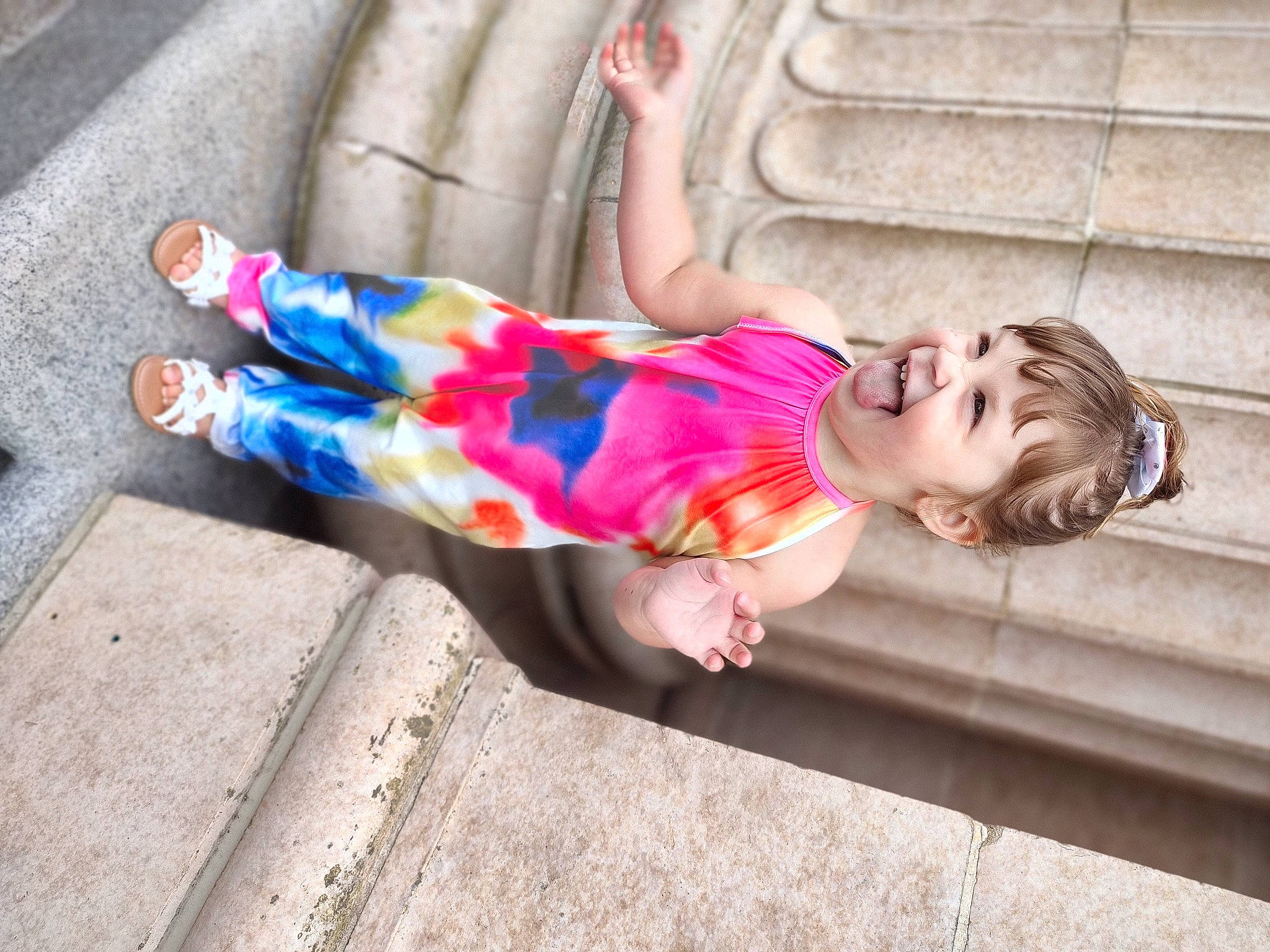 Avery joined the competition — help win amazing prizes! baby, baby_toddler_clothing, child, dress, electric_blue, fun, grass, happy, human_leg, leisure, magenta, pattern, person, play, recreation, sandal, sitting, thigh, toddler, tree