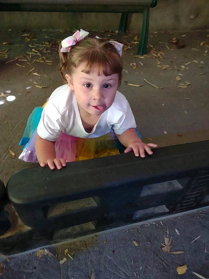 Avery is registered to the contest to win money with this photo: asphalt, baby, baby_toddler_clothing, child, city, concrete, fun, grass, hand, happy, human_body, leisure, person, play, road_surface, sidewalk, sitting, smile, t_shirt, toddler