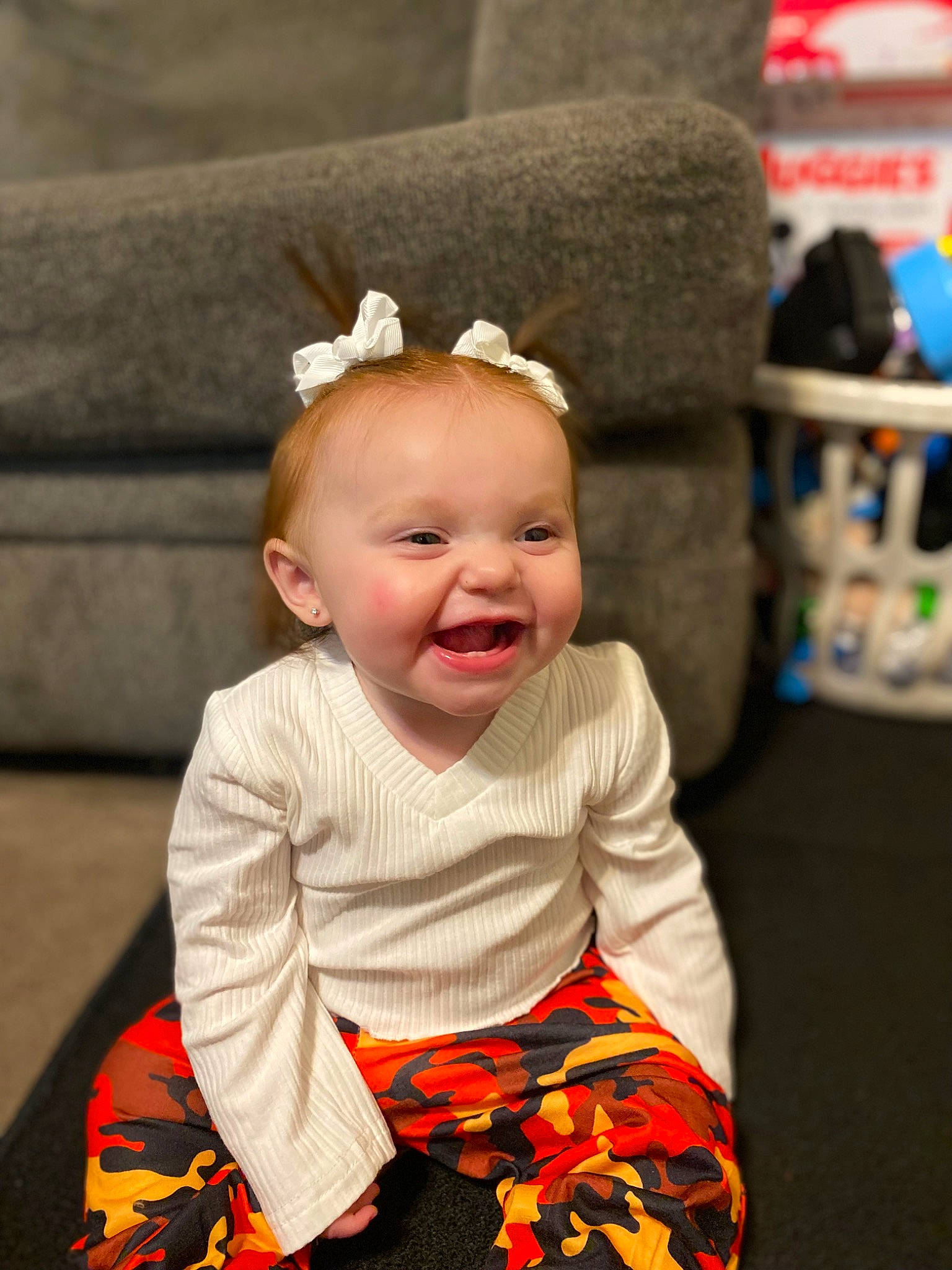 Aliana joined the competition — help win amazing prizes! baby, baby_toddler_clothing, child, costume_hat, eye, face, facial_expression, flooring, fun, happy, orange, pattern, person, sitting, skin, sleeve, smile, standing, t_shirt, toddler