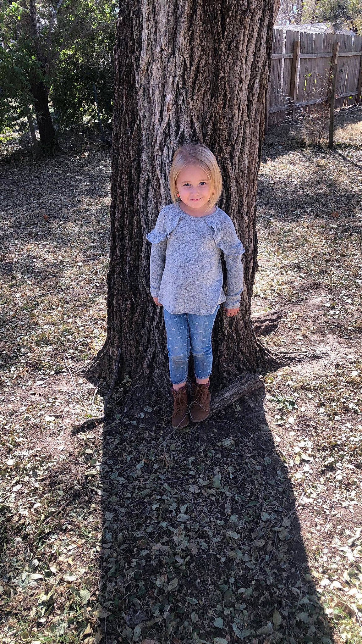 Chevelle is registered to the contest to win money with this photo: branch, child, denim, grass, jeans, joy, leaf, person, photography, plant, play, smile, standing, toddler, tree, trunk, woody_plant