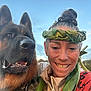 Elvis joined the competition — help win amazing prizes! woman, dog, german_shepherd, smiling, leaf_crown, leaf_necklace, outdoor, sky, happy, portrait, animal, pet, nature, friendship, closeup, canine, face, hair, clothing, collar