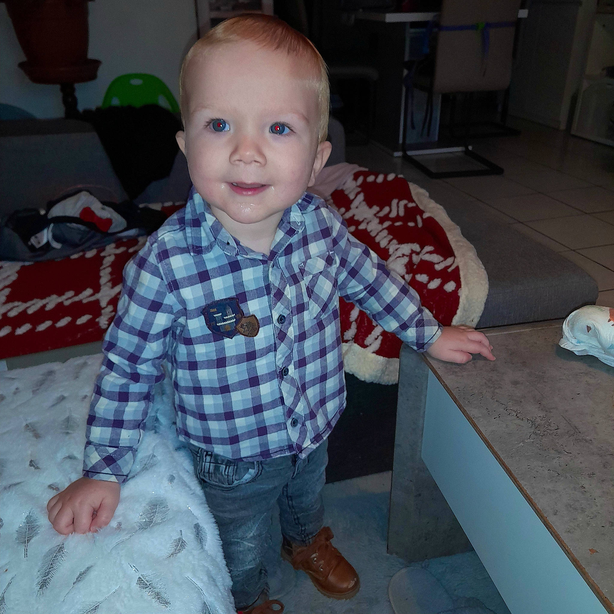 Louka participe au concours pour gagner de l'argent avec cette photo : baby, baby_toddler_clothing, child, eye, floor, flooring, fun, head, joy, living_room, mouth, pattern, person, plaid, room, sitting, sleeve, smile, t_shirt, tartan